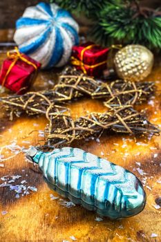 Vintage antique decorations for Christmas trees on bright yellow wooden background.