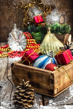 Wooden box filled with old fashion Christmas decorations.Photo tinted.