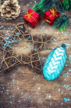 Festive Christmas decorations on wooden background in vintage style.Photo tinted.