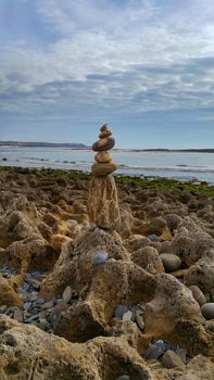 stone stacked pile on the beach of Milfontes in Portugal