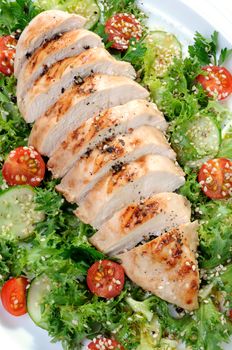 Cut into slices of grilled chicken breast with vegetable garnish