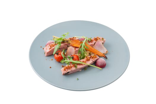Roasted duck breast in modern cuisine style with vegetable and herbs isolated on white background with clipping path