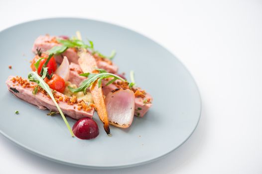 Roasted duck breast in modern cuisine style with vegetable and herbs