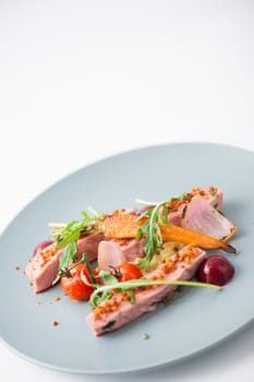 Roasted duck breast in modern cuisine style with vegetable and herbs
