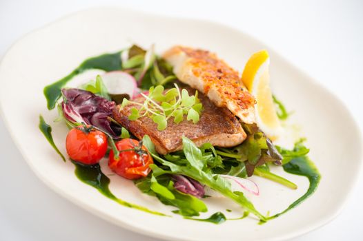 Modern style clean food, grilled salmon with toast and salad dressed with green sauce