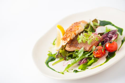 Modern style clean food, grilled salmon with toast and salad dressed with green sauce