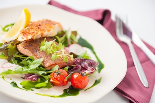 Modern style clean food, grilled salmon with toast and salad dressed with green sauce