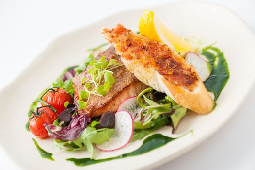 Modern style clean food, grilled salmon with toast and salad dressed with green sauce