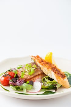 Modern style clean food, grilled salmon with toast and salad dressed with green sauce