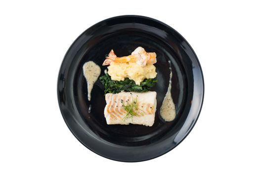 Cod fish steak with shrimp, mesh potato, and vegetable, modern style food isolated on white background with clipping path