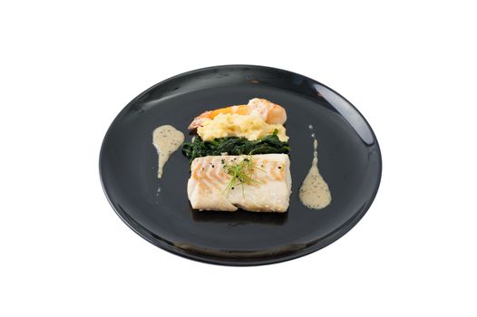 Cod fish steak with shrimp, mesh potato, and vegetable, modern style food isolated on white background with clipping path