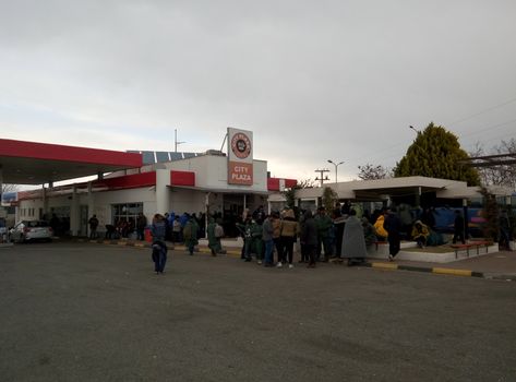 GREECE, Polykastro: Immigrants gather at the outside of a gas station in Polykastro, Greece on February 5, 2016. Their trek into Europe has come to a halt as Macedonian authorities have delayed in accelerating the journey. Thousands are now stranded near the border. 