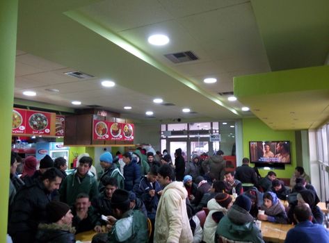 GREECE, Polykastro: Migrants flood the EKO gas station outside of Polykastro, Greece on February 5, 2016. Their trek into Europe has come to a halt as Macedonian authorities have delayed in accelerating the journey. Thousands are now stranded near the border. 