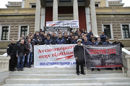 GREECE, Athens: Retired, active military and security personnel hold banners on February 5, 2016, in Athens, Greece.This week has seen extensive protests throughout Greece as people have denounced the government pension reforms as part of the bailout.