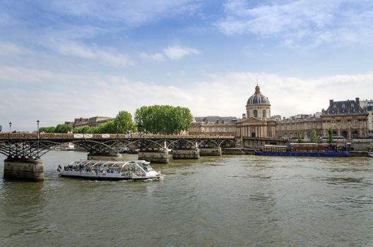 Institut de France and the Pont des Arts bridge across river Seine in Paris, France.