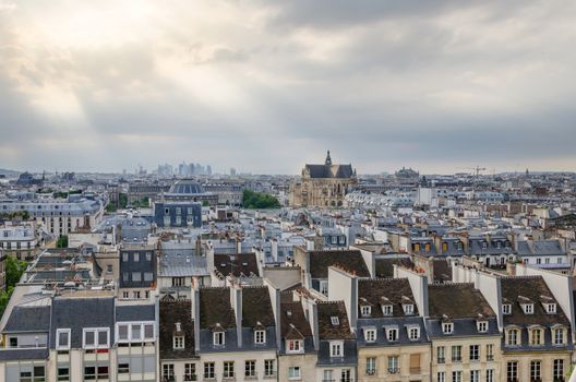 Saint-Germain l'Auxerrois church among roofs of paris. View form Pompidou Center