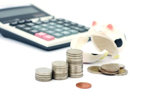 Thai stack coins in financial concept on white background, graph stack coin with accounting calculator and broken piggy bank
