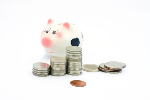 Thai stack coins with piggy bank on white background, financial concept photo