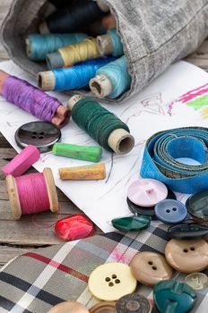 bag sewing thread and a sketch on a wooden table