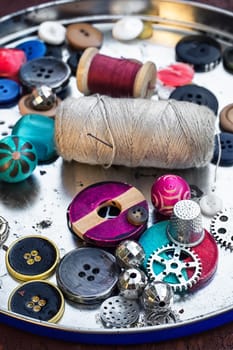 set of threads and buttons on old wooden background