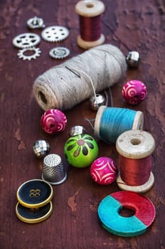 set of threads and buttons on old wooden background