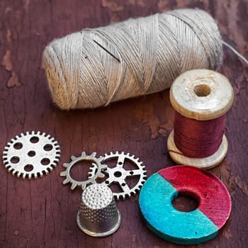 set of threads and buttons on old wooden background