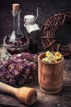 Cut  bunch medicinal plants,mortar on wooden table.Toned.