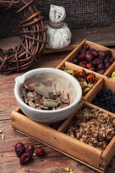 Cut  bunch medicinal plants,mortar on wooden table.Toned.