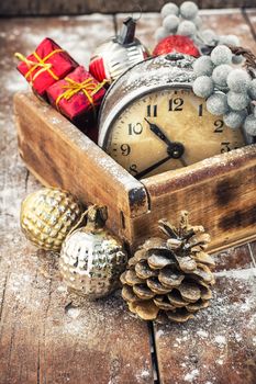 Old clock in  wooden box lined with Christmas decorations