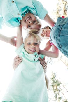 Group of smiling children looking down into camera