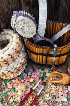 Scrub,brush,nail file in wooden tub on the background scattered with sea salt for Spa treatments.
