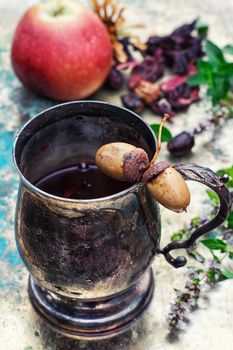 Herbal tea in iron stylish mug for medicinal herbs with fruit