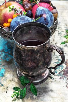 Herbal tea in iron stylish mug for medicinal herbs with fruit
