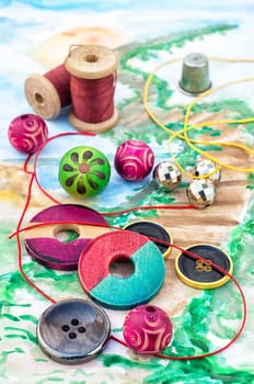 accessories of beads and threads for needlework on wooden plank