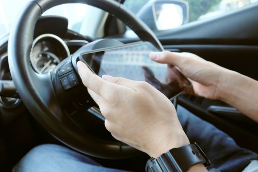 image of using a digital tablet inside of a car.