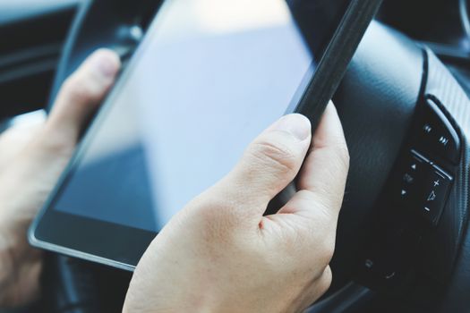 image of using a digital tablet inside of a car.