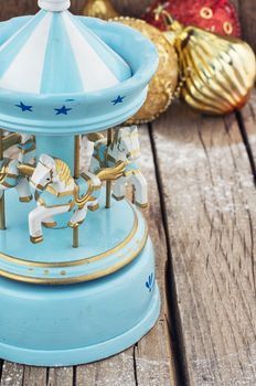 retro Christmas toys on the background of the souvenir carousel with horses