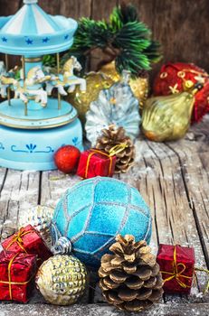retro Christmas toys on the background of the souvenir carousel with horses