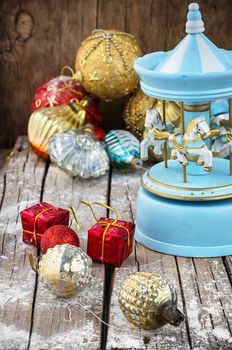 retro Christmas toys on the background of the souvenir carousel with horses