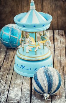 retro Christmas toys on the background of the souvenir carousel with horses