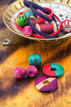 beads and jewelry for handmade on light orange plate