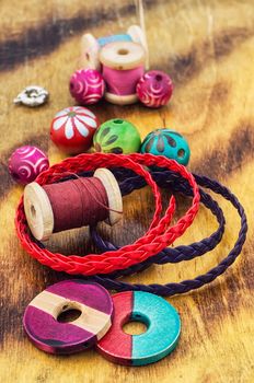 beads and jewelry for handmade on light orange plate