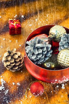 Christmas decoration for decorations on snowy wooden background.Photo tinted.
