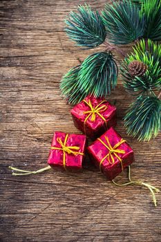 three decorative gift red boxes under the tree for Christmas holiday
