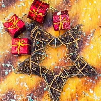 Souvenir decorative star wire Christmas on yellow plates.Photo tinted.