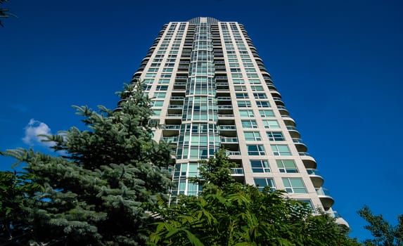 Looking up.  View on the corner of a new Condominium building project.  Modern living, urban buildings.