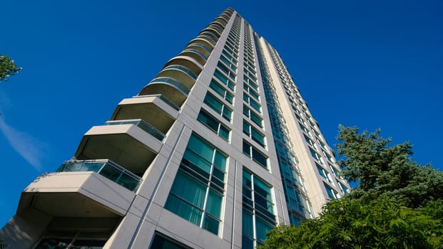 Looking up.  View on the corner of a new Condominium building project.  Modern living, urban buildings.