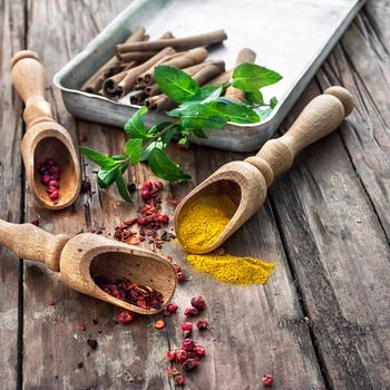 Set of different spices on the old wooden table.Photo rustic