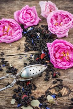 buds of the tea roses in wooden box with welding in rustic style