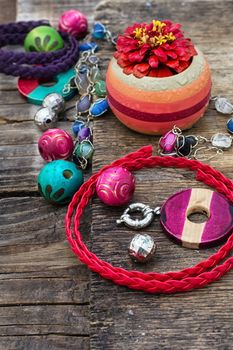 accessories of beads and threads for needlework on wooden plank